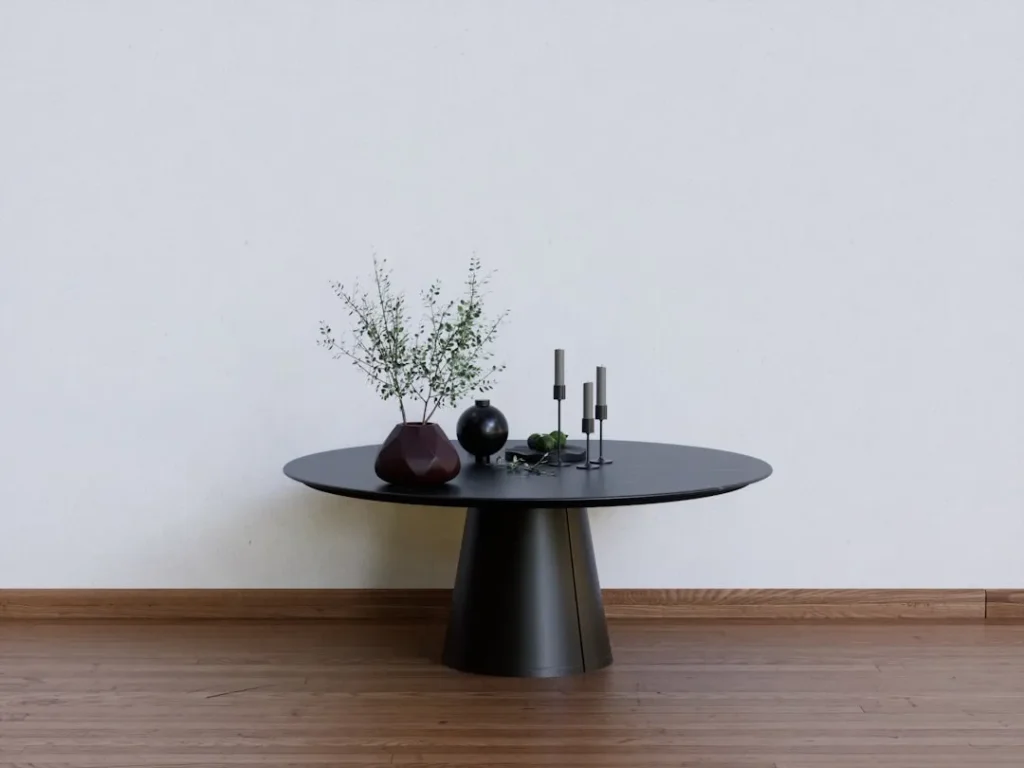 a black table with two vases on top of it