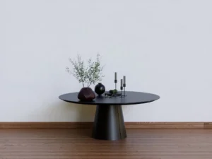 a black table with two vases on top of it