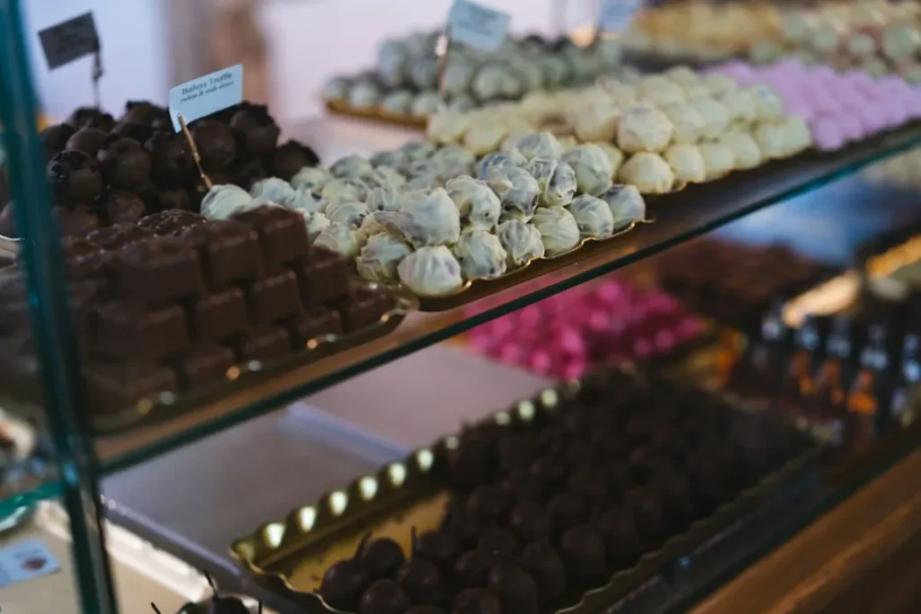 a display case filled with lots of different types of chocolates